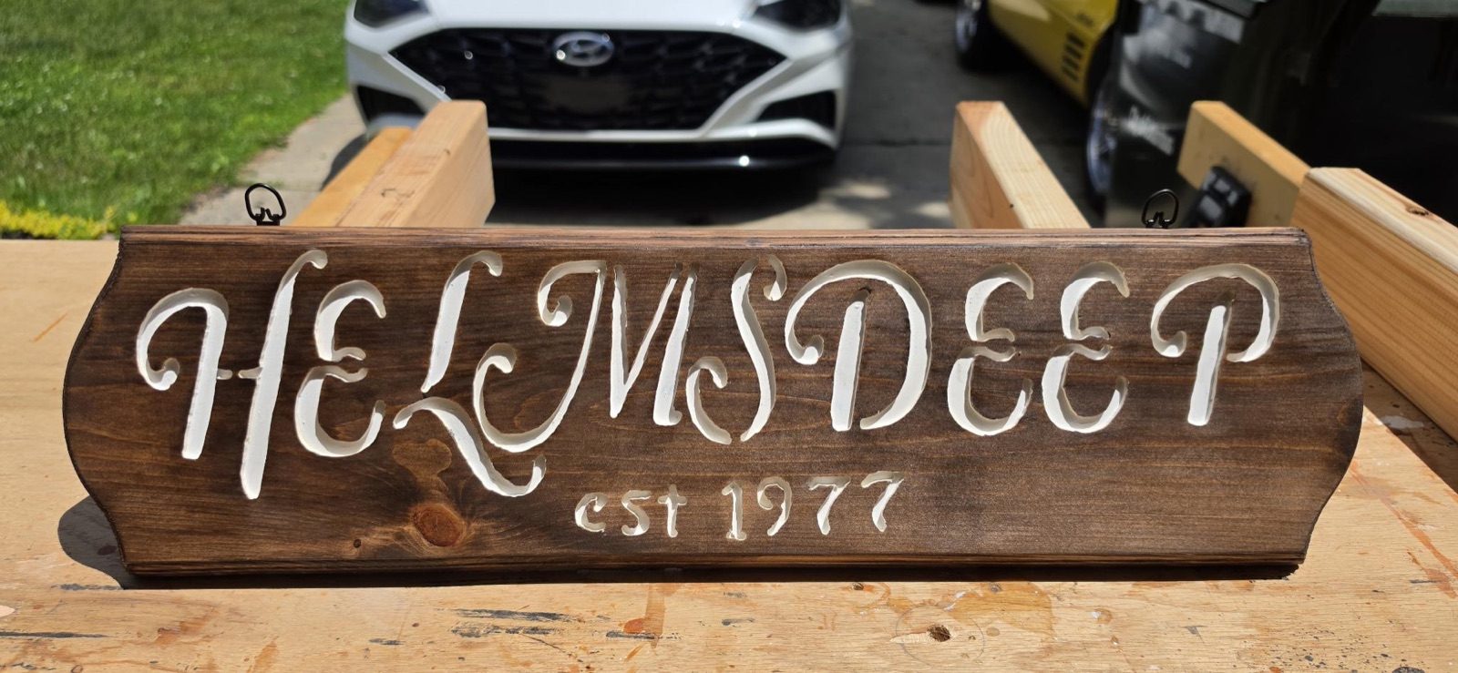 Stained sign with painted script — Helmsdeep, est. 1977