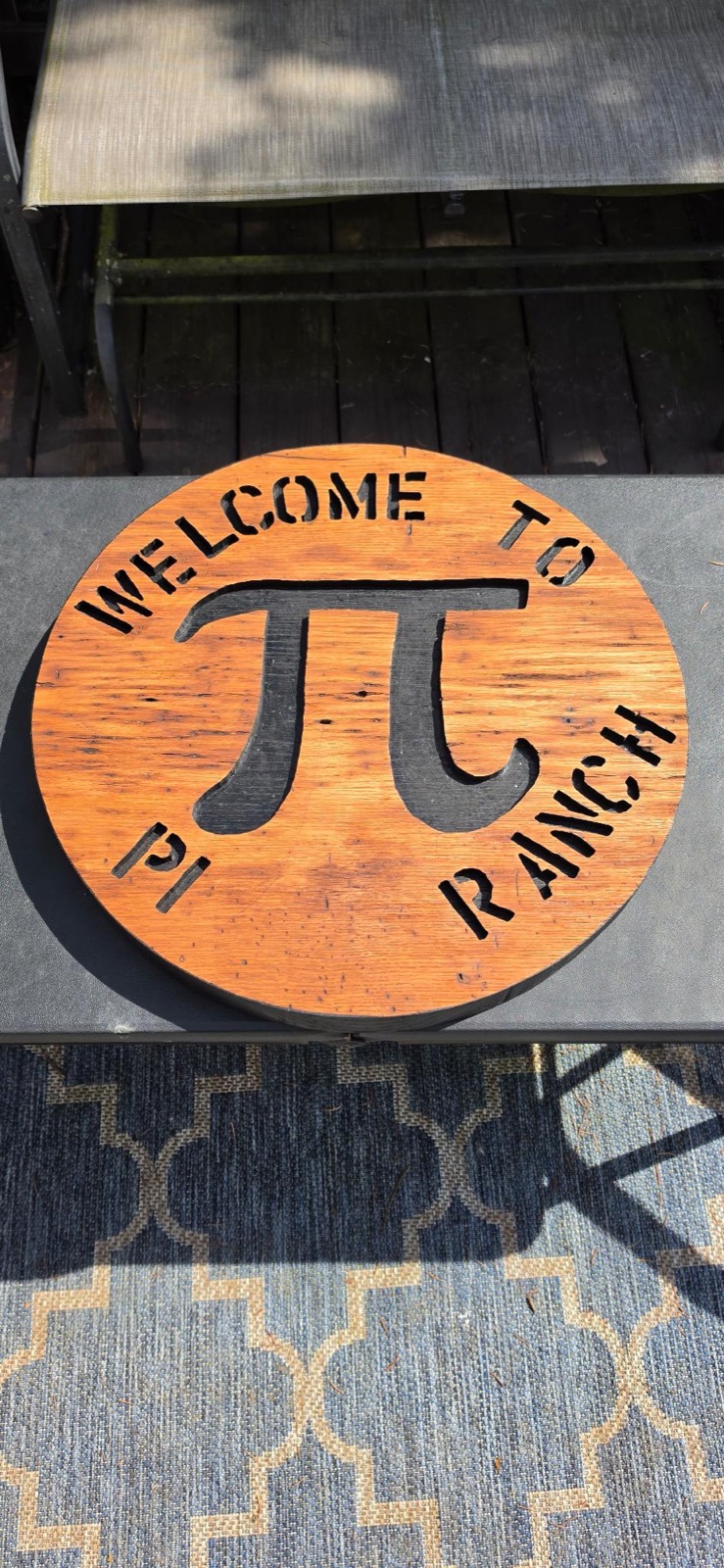Round oak ranch sign with cutout Pi symbol